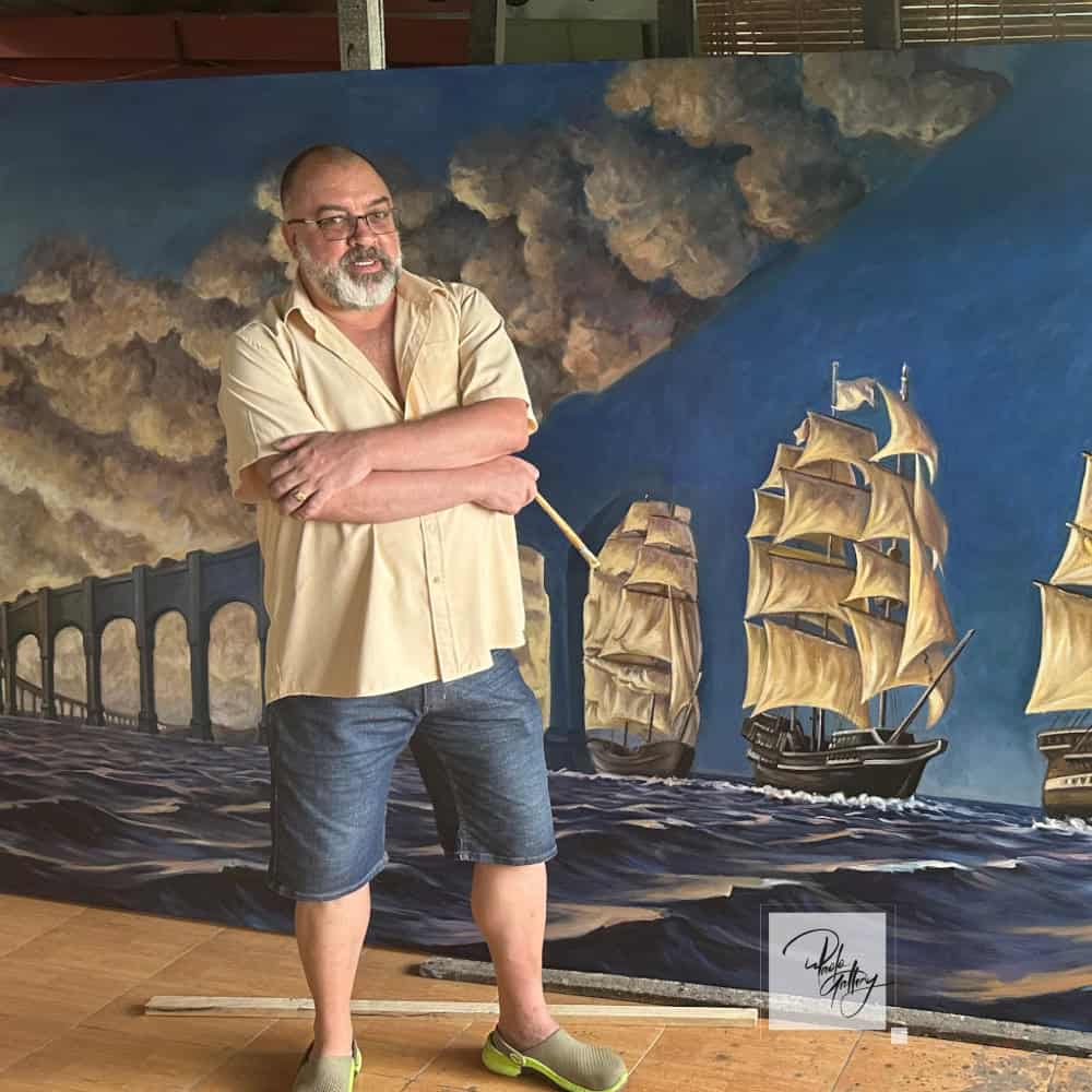 Paolo, founder of Paolo Gallery, in his studio with large canvas paintings